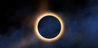 Solar eclipse with bright corona around dark moon