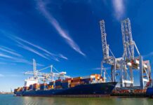 Putin Threatens to Seize European Ships Container ship docked at port with cranes loading cargo