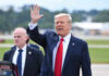 Trump’s Ireland Visit Brings Massive Security Operation Donald Trump waves while walking outdoors with security nearby