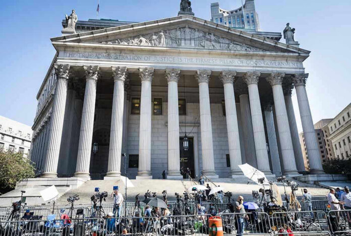 Reporters and photographers gathered outside a neoclassical courthouse