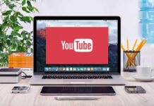 Documentary Ads Flagged as Political YouTube logo on a laptop screen on desk.