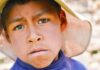boy wearing a wide-brim hat in a close-up portrait
