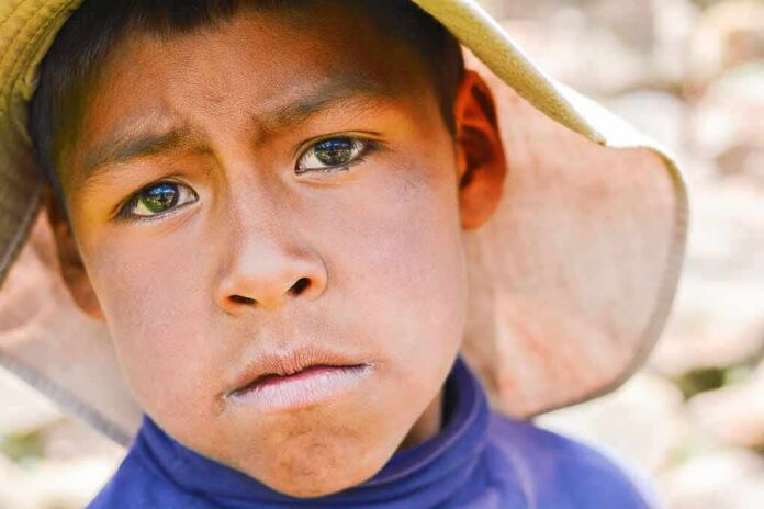 shutterstock_1079954018-1 boy wearing a wide-brim hat in a close-up portrait