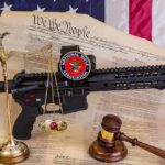 AR-15 Ban Gamble Hits High Court Rifle with NRA badge on Constitution backdrop with scales and gavel