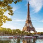 Eiffel Tower “Hides” Women During Hindu Visit Eiffel Tower in Paris with boats on the river and green trees
