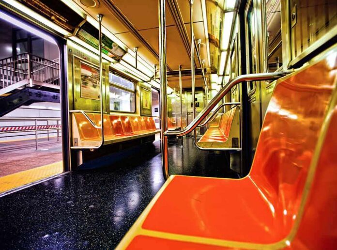 shutterstock_112362902 Empty subway car with orange seats and open doors
