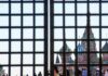 Bishop Bans Traditionalist Group From Leading Public Prayers St. Basil's Cathedral seen through a metal grid