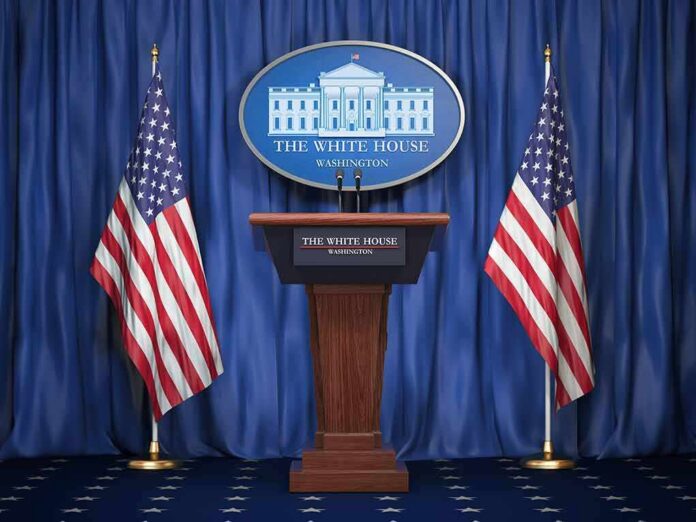shutterstock_1159933525-1 White House press podium with microphones and two American flags