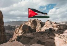 Concert Uproar Erupts: “Free Palestine” Chants Ignite Palestinian flag waving over rocky desert cliffs