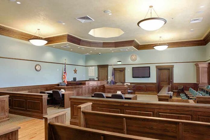 shutterstock_1349439551-6 Empty courtroom with wooden benches and judge's bench