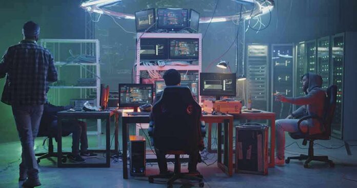 People working at computers in a dim server room