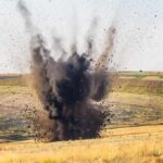Emergency Pipeline: U.S. Rushes More Bombs to Israel Explosion sending dark smoke and debris into the air in an open field
