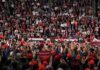 Trump Pushes Tougher Crime Policies Speaker at podium addressing large crowd in arena