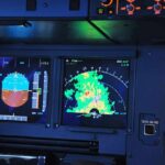 aircraft cockpit displays with attitude indicator and weather radar