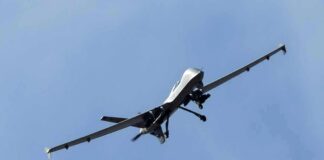 military drone flying in a clear blue sky