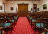 Full House Star Drops Divorce Bomb After 29years Courtroom with wooden benches facing the judge's bench