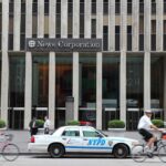 News Corporation building entrance with NYPD car and cyclists