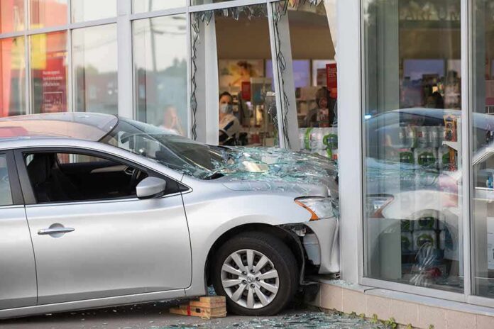shutterstock_1769535560 Silver car crashed into storefront window