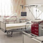 A hospital room featuring empty patient beds and medical equipment