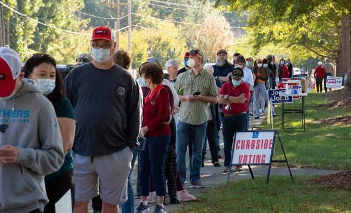 Christian Jones and others waiting in a long line outside a polling place