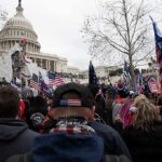 crowd with flags gathered outside the U.S. Capitol building
