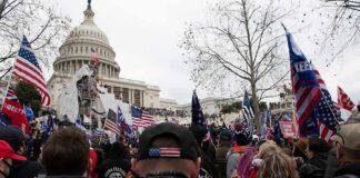 crowd with flags gathered outside the U.S. Capitol building
