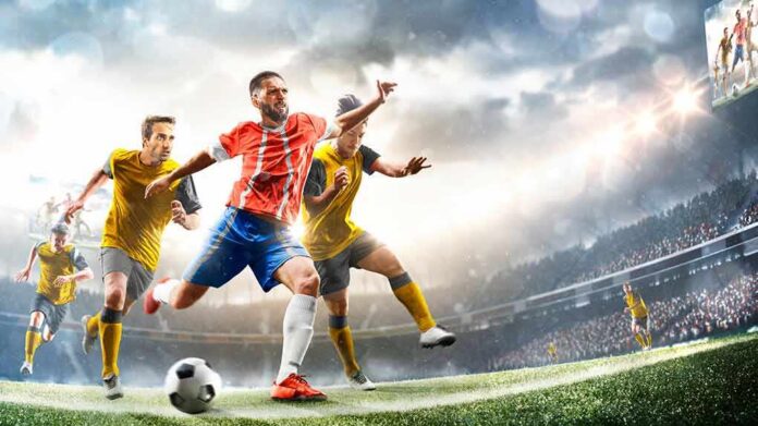 Soccer player in red jersey sprints past defenders in a stadium