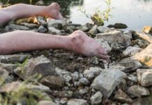 bare legs on rocky riverbank