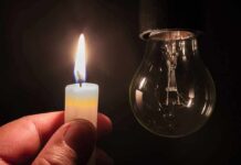 Cuba’s Entire Power Grid Collapses candle flame held near an unlit light bulb