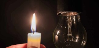 candle flame held near an unlit light bulb