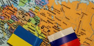 Ukraine and Russia flags on a map of Eastern Europe