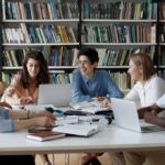 Students collaborating at a table in a library