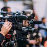 Judge Advances Murder Case Against Pop Star Video cameras on tripods at a media event