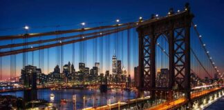 Manhattan Bridge with city skyline at dusk