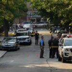 Crowd Flees as Gunfire Erupts Outside Minneapolis Club Police officers secure a residential street with patrol cars and yellow tape