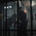 California Pastor Jailed on $17.5 Million Bail police officer at a jail cell with detainees behind bars