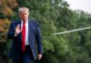 Donald Trump walking outdoors and waving