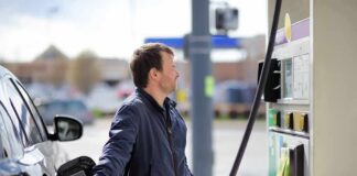 Man refueling a car at a gas station pump
