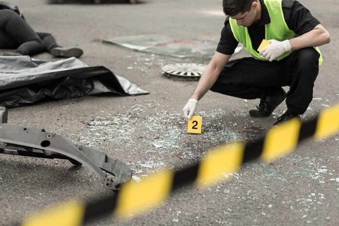 Forensic investigator marking evidence at crash scene