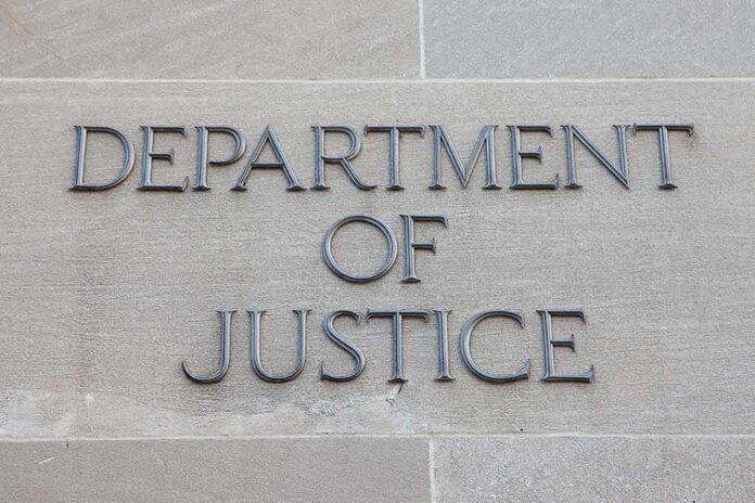 shutterstock_506478736-1 Department of Justice inscription on stone wall