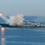 U.S. Strikes Iranian Military Sites Near Strait of Hormuz Warship launching a missile at sea