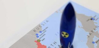 Blue toy rocket on a map of North Korea and surrounding countries
