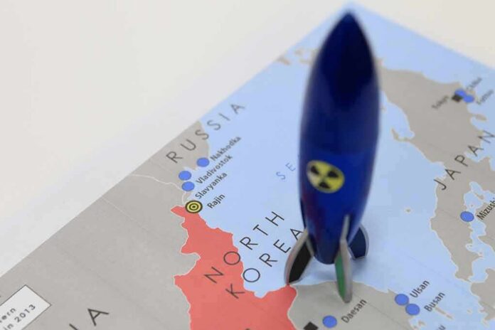 Blue toy rocket on a map of North Korea and surrounding countries