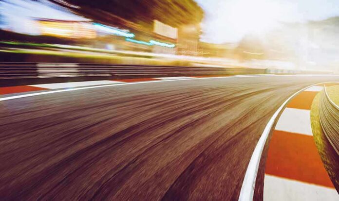 shutterstock_563321110 race track curve at sunset with motion blur