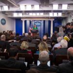 One Speech, One Line, and a Political Firestorm Press secretary at podium addressing reporters in briefing room