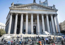 Federal Probe Continues With No Charges Filed Reporters and photographers gathered outside a neoclassical courthouse