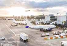FlyDubai Flight Diverts After Cockpit Attack Airplanes at airport gates during sunset with ground vehicles and jet bridges