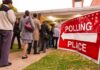 Voters standing in line outside a polling place