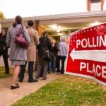 Voters standing in line outside a polling place
