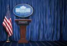 U.S. Targets Court Over Israel, U.S. Cases White House press briefing podium with U.S. flag and blue curtain